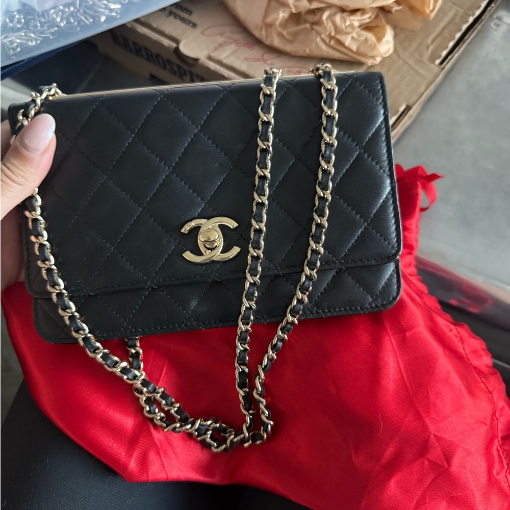 CHANEL Black Quilted Crossbody wallet on chain.